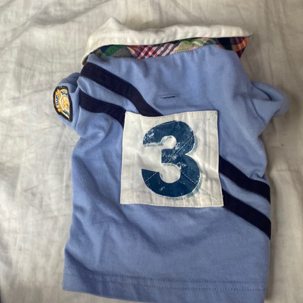 Ralph Lauren small baby blue # 3 with a pop caller, and RL logo on right arm.